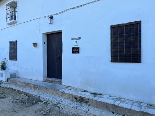 a door on the side of a white building at La Casilla in Montilla