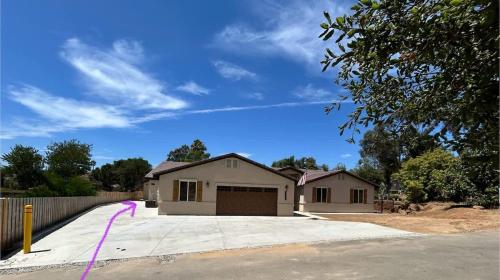 a house with a garage on a driveway at The Little Oasis in Escondido