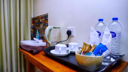 a bathroom counter with a sink and two bottles of water at Sigiri SAAT Cabana in Sigiriya