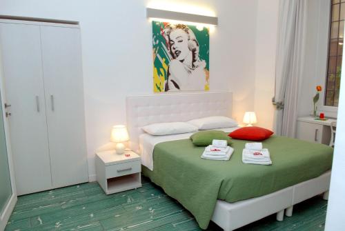a bedroom with a bed with two towels on it at Divine Bed & Breakfast in Rome