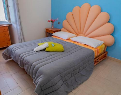 a bedroom with a large bed with a large headboard at MARE NOSTRUM - Beachfront House with Sea View - 2 Bedrooms - Sant'Angelo Ischia in Sant'Angelo D'Ischia