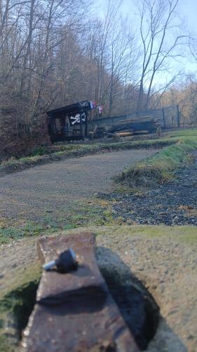a car is parked on the side of a road at Log Cabins Jovicic in Bosanska Dubica