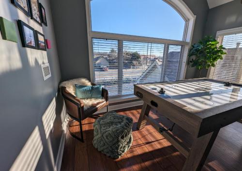 a room with a desk and a chair and a window at Relaxing Condo on the River - NEW Air Hockey Table in Pigeon Forge
