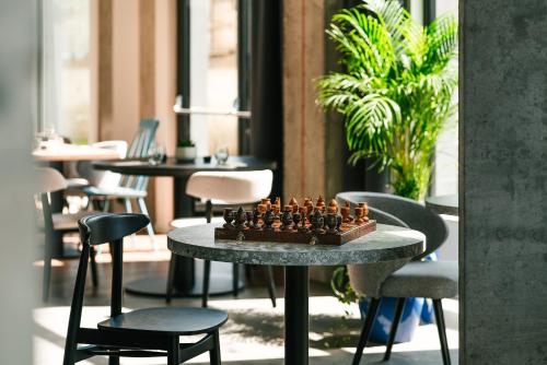 a chess board on a table in a restaurant at Hotel Convictus Cracovia for business & travellers in Kraków