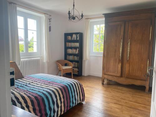 a bedroom with a bed and a book shelf at Maison de famille chaleureuse, plage à pied in Saint-Cast-le-Guildo