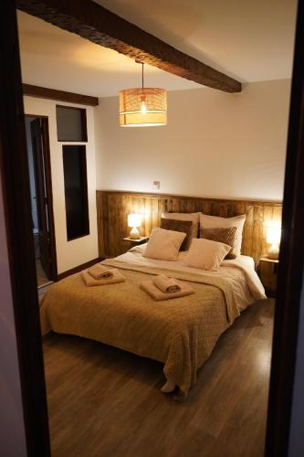 a bedroom with a large bed with two towels on it at Appartement Cime - Confort & Charme in Saint-Gaudens