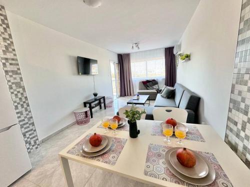 a living room with a table with fruit on it at Stay With Oleg 102A in Paralimni
