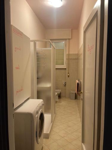 a bathroom with a washer and dryer in a room at Fòndaco Scandicci in Scandicci