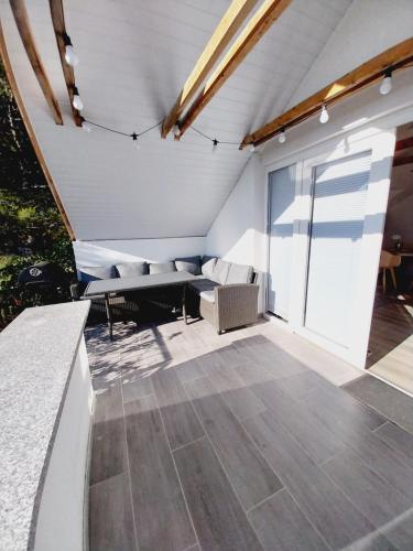 a patio with a couch and a table at Apartments Filip & Nina in Vir
