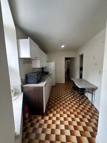 a small kitchen with a counter and a table at AL Shami 408 in New York
