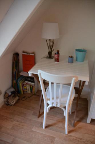 - une table et des chaises blanches dans la chambre dans l'établissement Maison à l'Océan, à Batz-sur-Mer