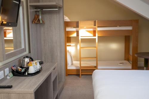a bedroom with a bed and a bunk bed at Hellidon Lakes Hotel in Daventry