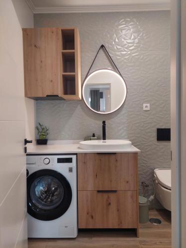 a bathroom with a washing machine and a sink at Apartment Studio Espiche near Praia da Luz in Luz