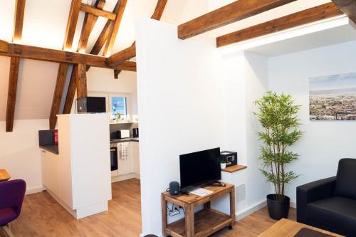 un soggiorno con pareti bianche e travi in legno di AMBERG APART - Apartment-Wohnung 3 - Wohnraum auf Zeit ad Amberg