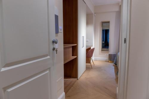a door leading into a room with a desk at Flat Urban Suites in Rome