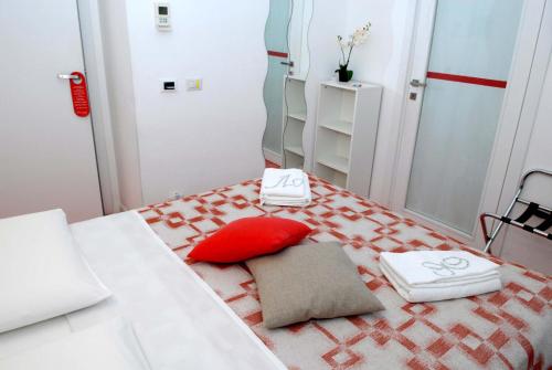 a small room with a bed with a red pillow at Divine Bed & Breakfast in Rome