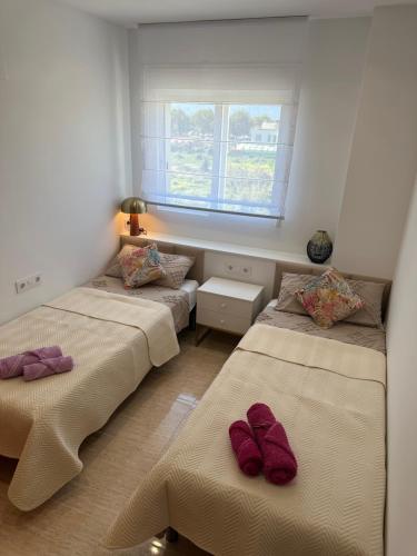 En eller flere senge i et værelse på Apartamento NARANJA GANDIA GRAU