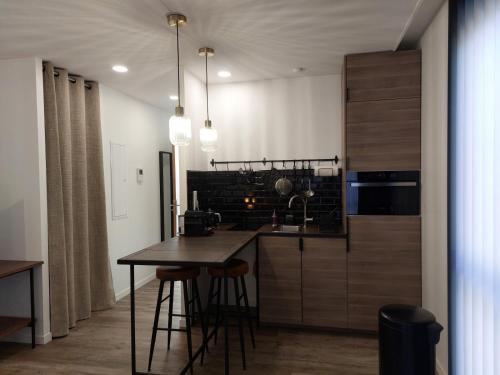 a kitchen with a table and a counter top at Urbs Amiens Sud in Amiens