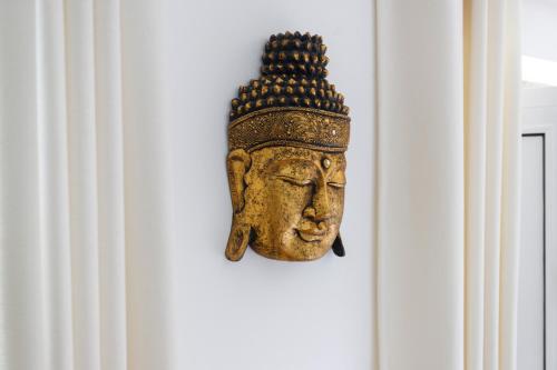 a statue of a head hanging on a wall at Quinta da Relva - Soulful House in Mafra