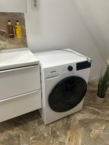 a white microwave oven sitting next to a stove at Aparthouse 1 in Lugoj