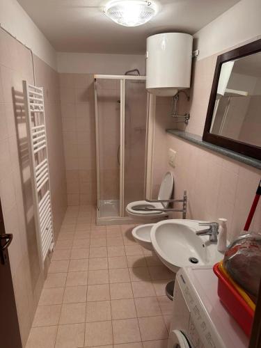 a bathroom with two toilets and a sink and a shower at Il nido d'Ala in Ala di Stura