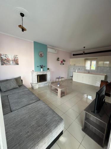 a large living room with a couch and a tv at ANASTASIA HOUSE in Sozopoli