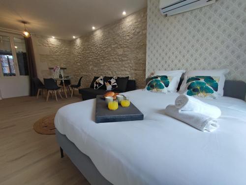 a bedroom with a large white bed with fruit on it at Studio Orchidea in Saint-Aignan