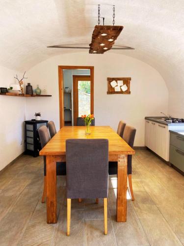 a dining room with a wooden table and chairs at Ca' Berti Teglio in Teglio