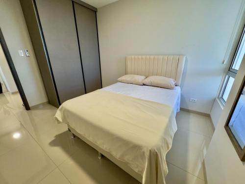 a bedroom with a bed with two pillows on it at Luxurious and Spacious Family Apartment in Curupau Isuto in Santa Cruz de la Sierra