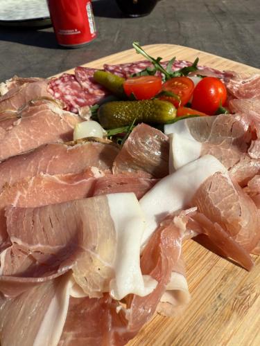 a wooden cutting board with meat and vegetables on it at Hotel-Restaurant Kostbar in Engen