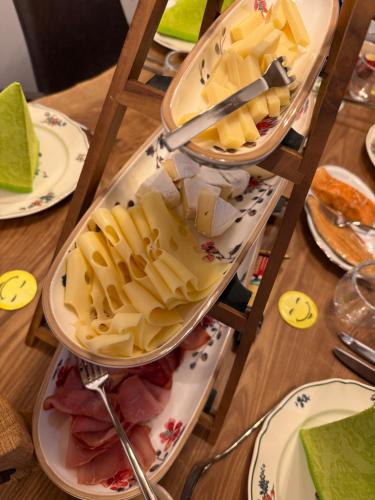 a table with three tiers of cheese and other foods at Hotel-Restaurant Kostbar in Engen