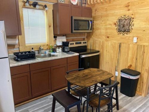 a kitchen with a sink and a table with chairs at Stairway to Heaven in Birdseye