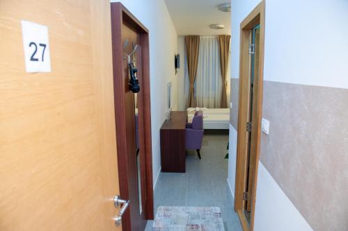 Ένα ή περισσότερα κρεβάτια σε δωμάτιο στο Hotel North City