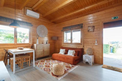 a living room with a couch and a table at Quinta da Relva - Soulful House in Mafra