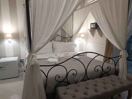 a bedroom with a black bed with a canopy at Relais Tiaré Bed and Breakfast in Bacoli