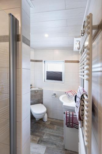 a small bathroom with a toilet and a sink at Haus-Lily-Nr-04 in Büsum