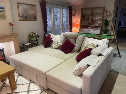 a living room with a couch and a pool table at Luxury lodge T11 in Hastings