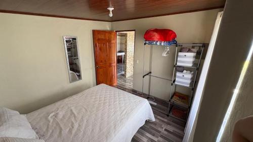 a small bedroom with a bed and a book shelf at Skyline Great View in Lourdes