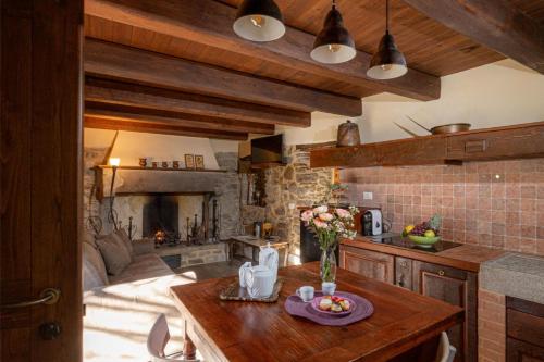 a kitchen with a table and a living room at Canto del Fiume in Ortignano Raggiolo