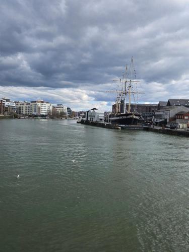 a boat is docked in a body of water at City Centre Location on Corn Street studio in Bristol