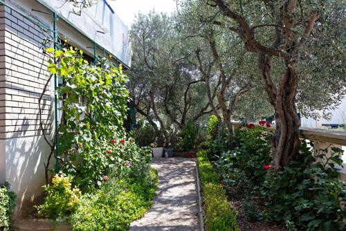 a garden with flowers on the side of a building at Guest house Mira in Pirovac