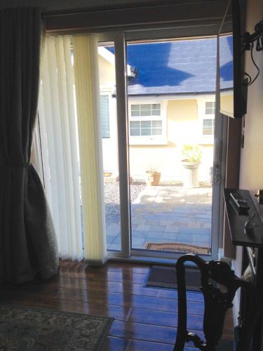 an open sliding glass door to a patio at Riverside Lodge in Carlingford