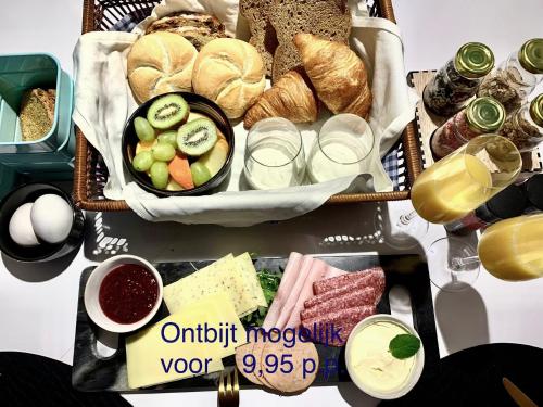 a table topped with baskets of different types of food at B&B bij Vincent in Nieuw-Amsterdam