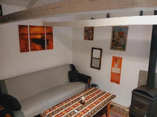 a living room with a couch and a wood stove at Log Cabins Jovicic in Bosanska Dubica