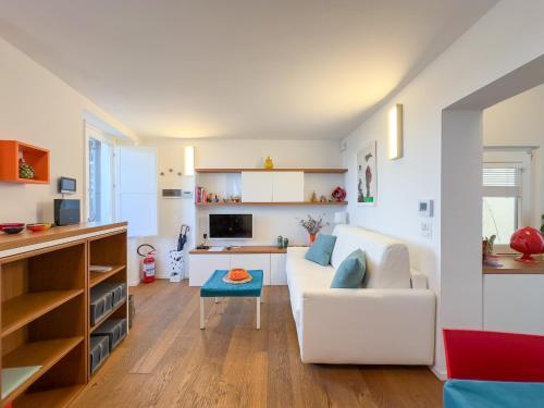 a living room with a white couch and a table at Casa Venezia San Nicola in Bari