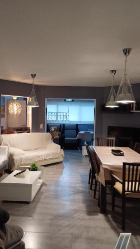 a living room with a white couch and a table at Villa Cambrils Mar in Cambrils