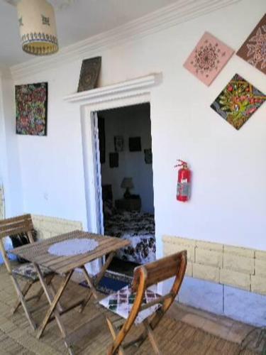 a dining room with a table and chairs in a room at Yamna home in Agadir