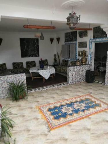 a living room with a couch and a rug at Yamna home in Agadir