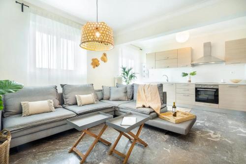 a living room with a couch and a kitchen at Chania Urban Living - Live like a local in Chania Town