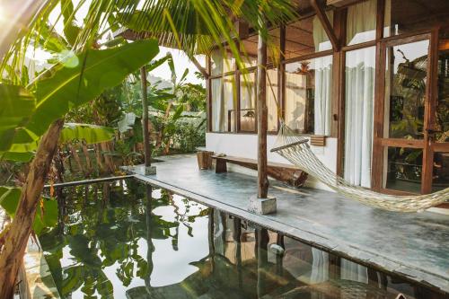 a villa with a hammock in the middle of a house at SatyaVilla6 in Havelock Island